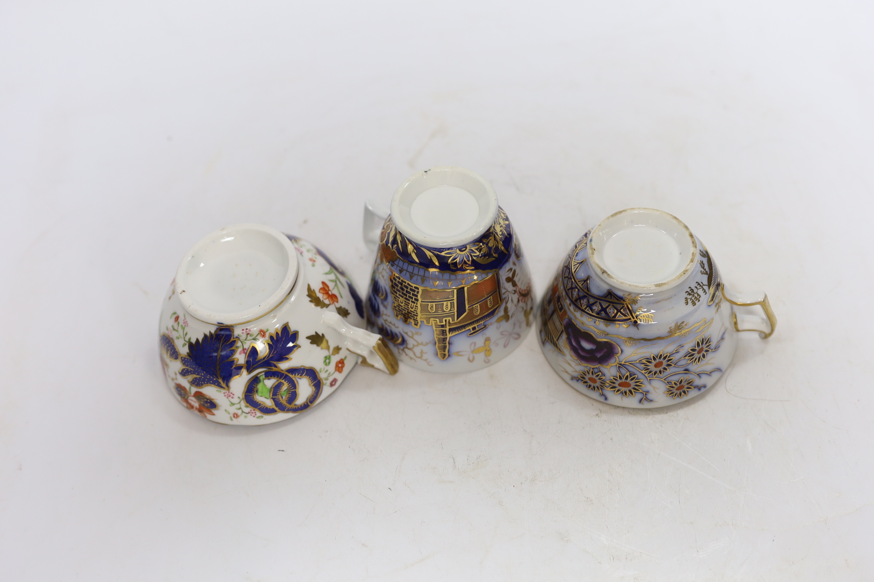 Eleven 1800-1820 English porcelain coffee cans and tea cups, including Imari pattern examples, one with matching saucer